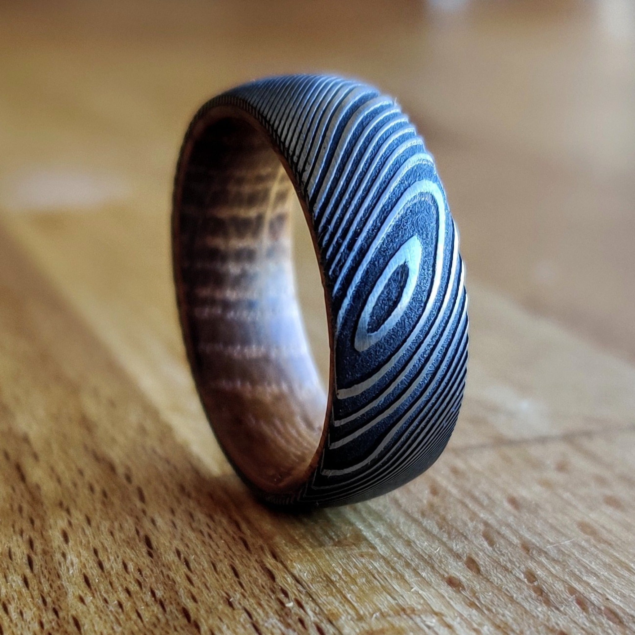 The-Murakami-Damascus-Steel-and-Whiskey-Barrel-Wedding-Ring-1.jpg The Murakami - Image 1